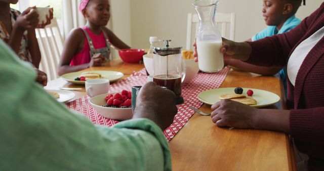 Family Having Breakfast Together Sharing Milk and Coffee - Download Free Stock Images Pikwizard.com