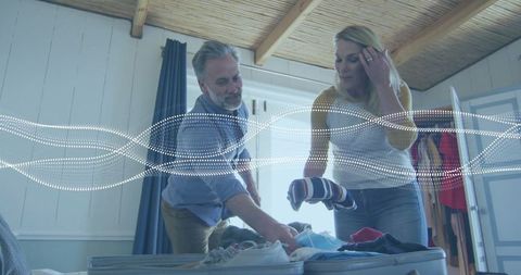 Mature couple packing suitcase for relaxing travel adventure