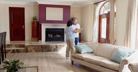 Senior Couple Using Tablet in Elegant Living Room