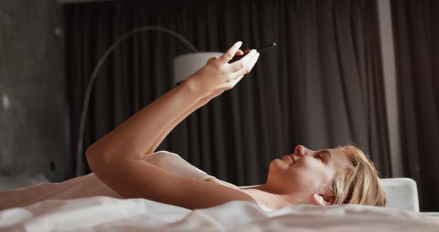 Woman Relaxing in Bed and Using Smartphone - Download Free Stock Images Pikwizard.com