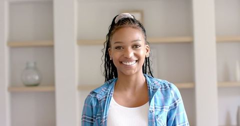 Laughing Young Woman with Braided Hair in Casual Outfit