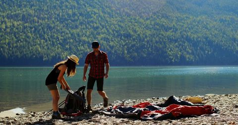Couple Preparing Gear for Outdoor Lake Adventure