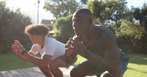 Diverse Friends Engaging in Outdoor Fitness Squat Exercise
