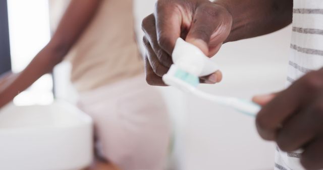 Close-up of Person Applying Toothpaste on Toothbrush in Bathroom - Download Free Stock Images Pikwizard.com