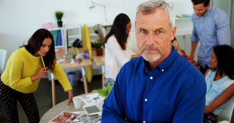 Focused Businessman in Dynamic Office Setting with Diverse Team Collaboration
