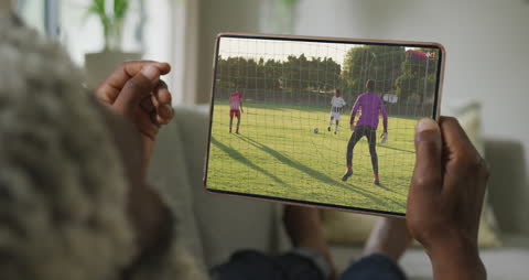 Watching Soccer Match on Tablet at Home