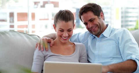 Couple Enjoying Relaxed Time Together with Laptop in Living Room - Download Free Stock Images Pikwizard.com