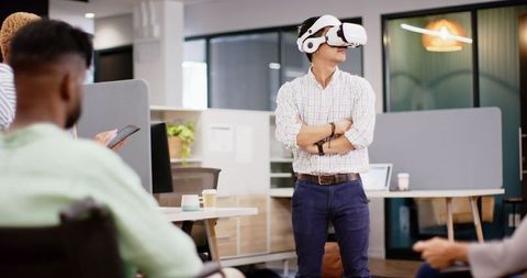 Businessman Using VR Headset in Innovative Office Meeting
