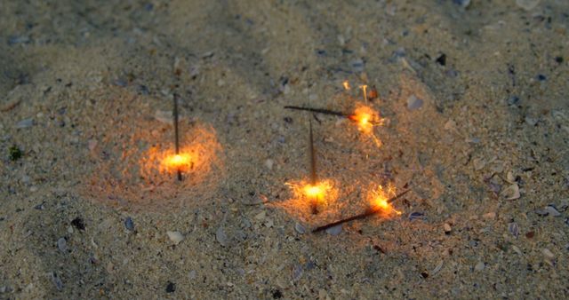 Sparklers Stuck in Sand on Beach Creating Playful Glow - Download Free Stock Images Pikwizard.com