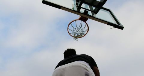 Basketball Player Aiming at Outdoor Hoop Silhouette