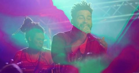 Energetic lead singer performing with guitarist on stage