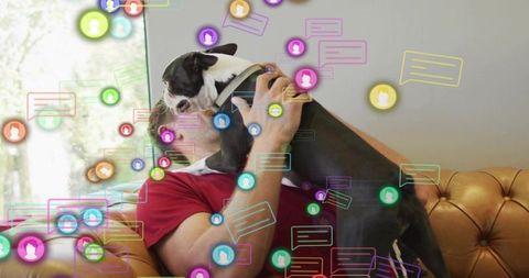Man and dog on couch embraced by digital connection icons