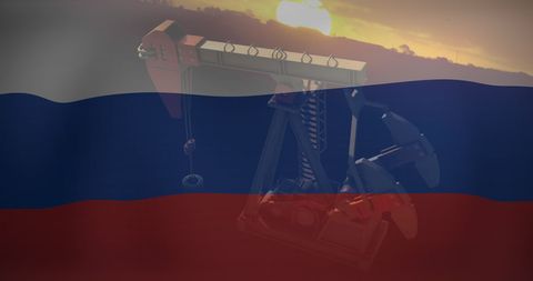 Oil pumpjack overlaid with russian flag at sunset