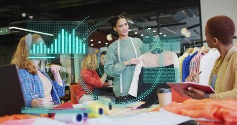 Designer Sharing New Fashion with Team in Modern Studio