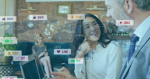 Colleagues Analyzing Digital Analytics Data in Modern Lounge Workspace