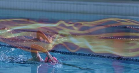 Female Swimmer Executing Backstroke with Vivid Light Trails
