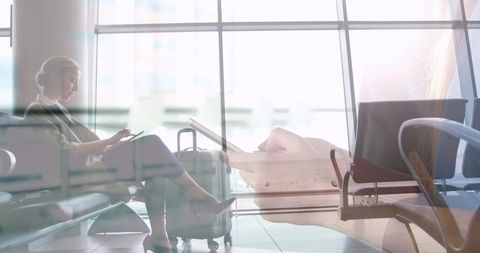 Businesswoman in Airport Lounge with Smartphone