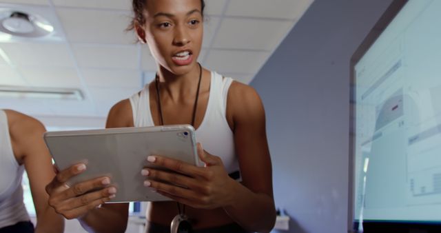 Fitness Trainer Analyzing Workout Data on Tablet - Download Free Stock Images Pikwizard.com