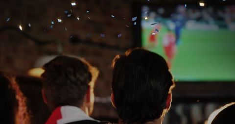 Fans Celebrating a Soccer Match in Energetic Pub Ambiance