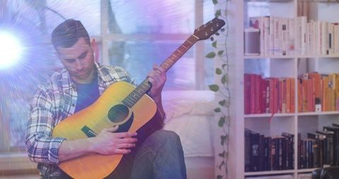 Singer Songwriter Composing Music on Acoustic Guitar at Home