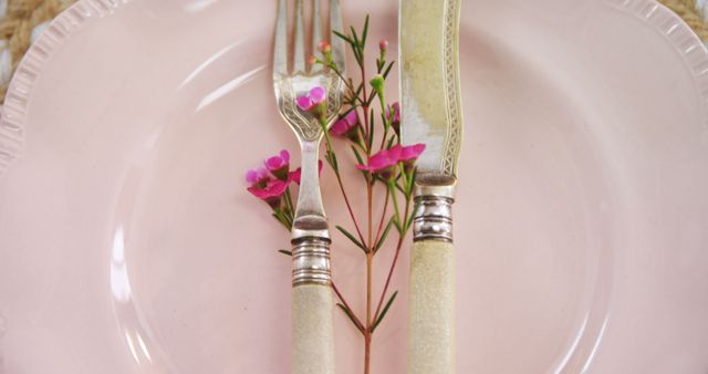 Elegant Table Setting with Fork and Knife on Pink Plate with Flowers - Download Free Stock Images Pikwizard.com