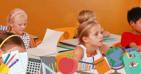 Attentive elementary student turning forward in classroom with school supplies overlay