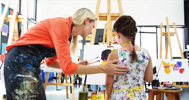 Art Instructor Guiding Young Student in Colorful Painting Class - Download Free Stock Images Pikwizard.com