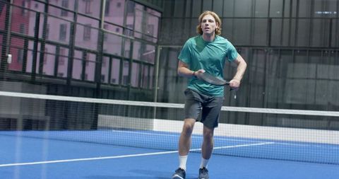 Male Athlete Concentrating on Paddle Tennis Court