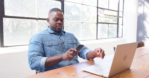 Professional African American Man Multitasking with Technology