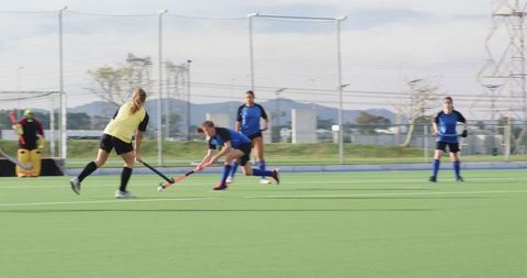 Women Compete in Intense Outdoor Field Hockey Match