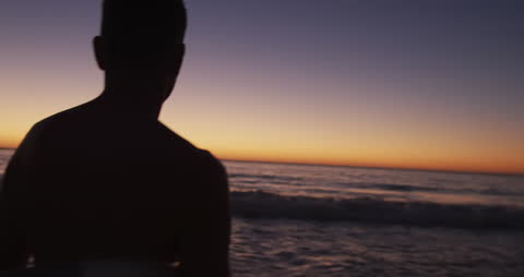 Silhouetted Man Watching Ocean Sunset Peacefully