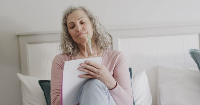 Senior Woman Reflecting While Writing in Notebook at Home - Download Free Stock Images Pikwizard.com