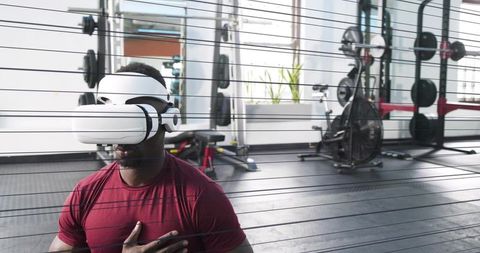 Practicing vr breathwork and mindfulness with headset, kneeling athlete wearing red shirt