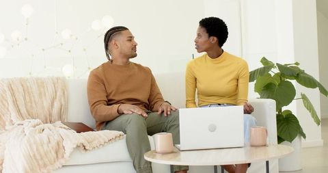 Diverse Couple Discussing in Bright Living Room