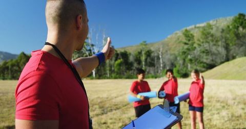 Outdoor Boot Camp Instructor Guiding Kids with Exercise Mats