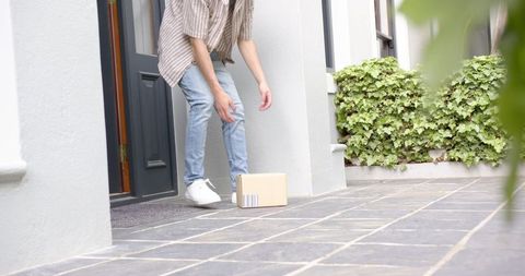 Person Receiving Parcel on Doorstep