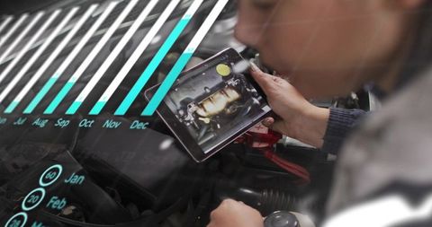 Technician holding tablet inspecting engine bay with digital HUD overlay and diagnostic charts
