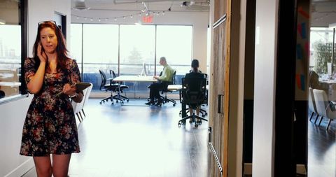 Businesswoman Conversing on Phone in Modern Office Space