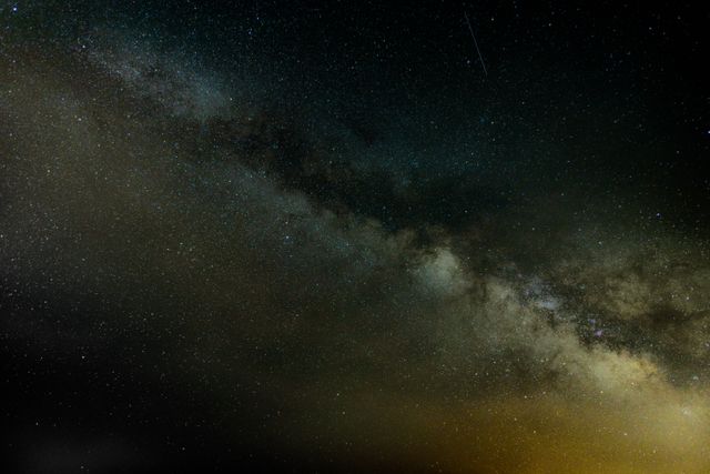 Milky Way galaxy viewed against a dark night sky filled with stars. Ideal for use in articles on astronomy, space exploration, astrophotography, and stargazing. Suitable for educational materials, science presentations, or inspiring desktop wallpapers.