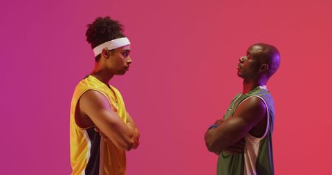 Diverse Basketball Players Facing Off Against Vibrant Background