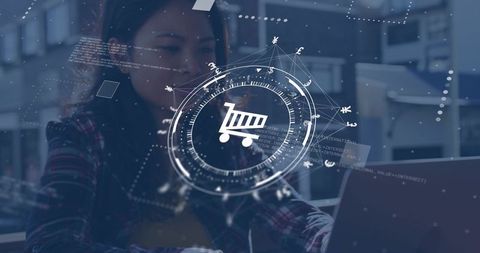 Working woman focusing on laptop with e-commerce shopping cart hud and data analytics overlay