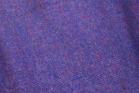 Purple wool tweed fabric with multicolor flecks close-up for design and fashion