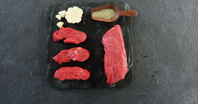 Raw Beef Steaks on Slate with Garlic and Rosemary - Download Free Stock Images Pikwizard.com