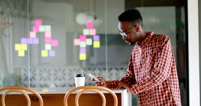 Young Professional in Checkered Shirt Using Smartphone - Download Free Stock Images Pikwizard.com