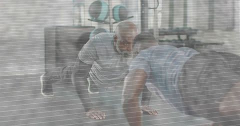 Two men doing push-ups together in gym training session partner workout focus motivation