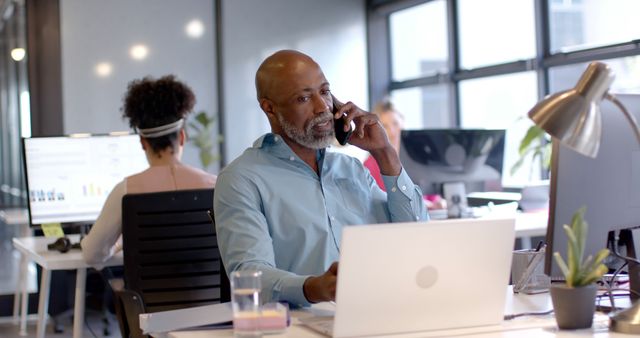 Mature Businessman on Phone Call in Modern Office - Download Free Stock Images Pikwizard.com