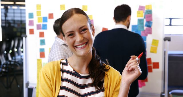 Cheerful businesswoman brainstorming ideas with team - Download Free Stock Images Pikwizard.com