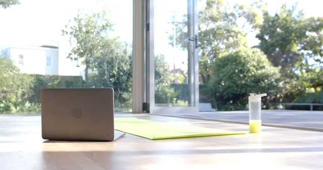 Yoga Mat with Laptop and Water Bottle in Sunny Room - Download Free Stock Images Pikwizard.com