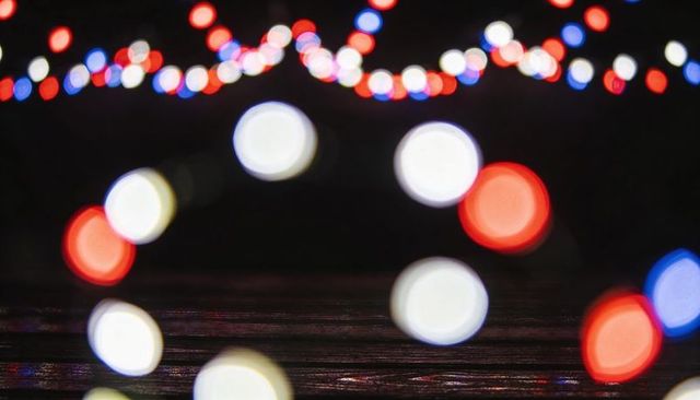 Red white blue bokeh lights on dark wooden tabletop for festive backdrop