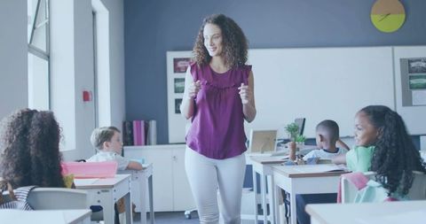 Elementary teacher engaging students in interactive classroom lesson with natural light